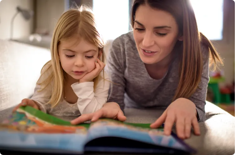 mother and daughter reading on the floor