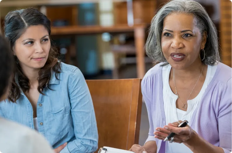 woman engaged in discussion with other people