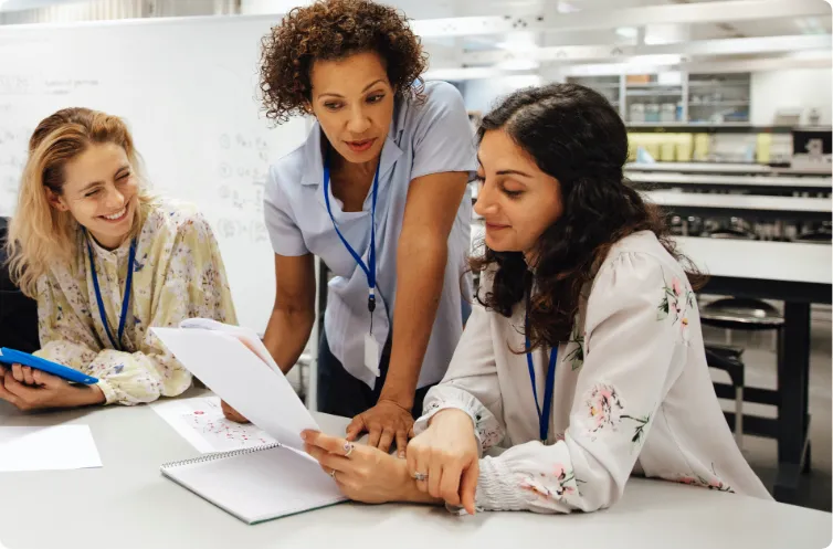 three woman engaged in discussion